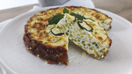 Fetta di torta di zucchine e ricotta chetogenica soffice e filante senza farina e senza glutine, interno con zucchine a cubetti